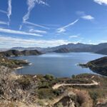 silverwood lake seen from a hillside above, green mountains and hills surround the lake