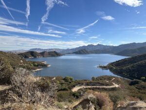silverwood lake seen from a hillside above, green mountains and hills surround the lake