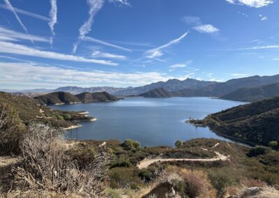 silverwood lake seen from a hillside above, green mountains and hills surround the lake